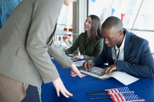 Volunteers checking voters in at polling place