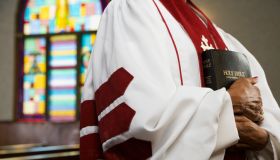 African American female Reverend holding Bible