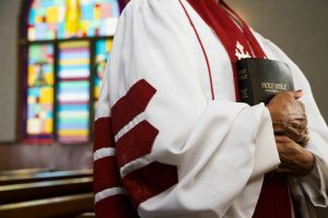 African American female Reverend holding Bible