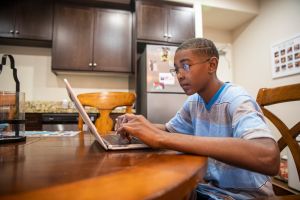 Young Black boy homeschooling