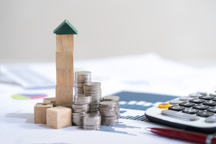 Bank calculates the home loan rate,Home insurance,engineer playing a blocks wood tower game (jenga) on blueprint or architectural project,growth concept