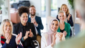 Multiracial businesspeople clapping in a management training workshop