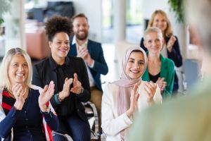 Multiracial businesspeople clapping in a management training workshop