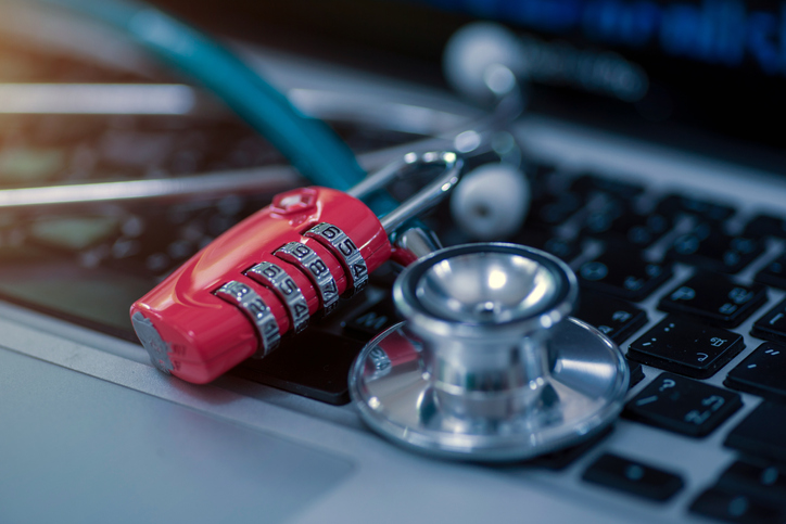 Stethoscope and padlock on a computer keyboard.