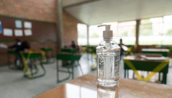 Hand sanitizer on a desk at a school classroom