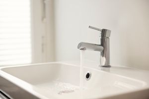 Water pouring from sink faucet