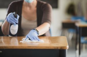 Teacher disinfecting the classroom