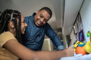 Father helping daughter sutdying at home