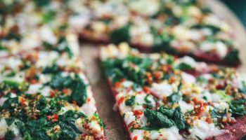 Vegan Pizza with Beet Base, Topped with Spinach and Vegan Cheese