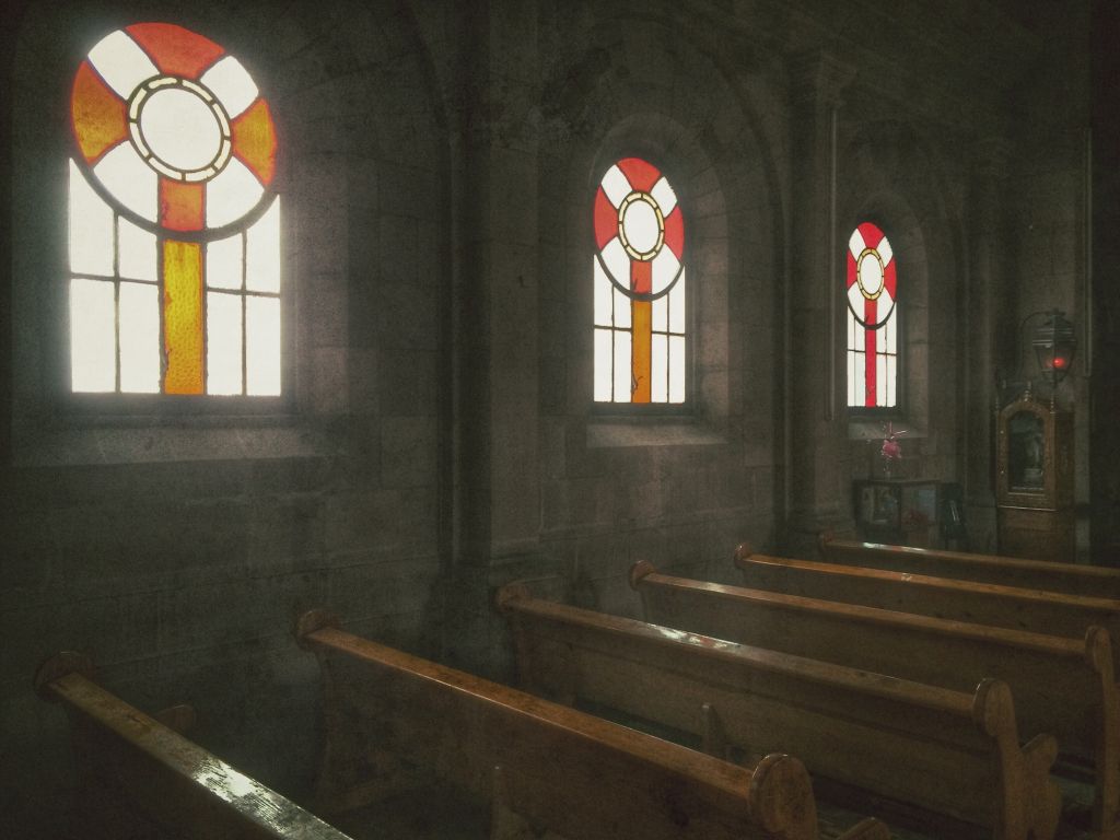 Stained Window Glass With Pews In Church