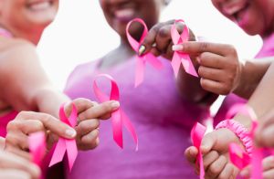 Group of women in pink, breast cancer awareness ribbons