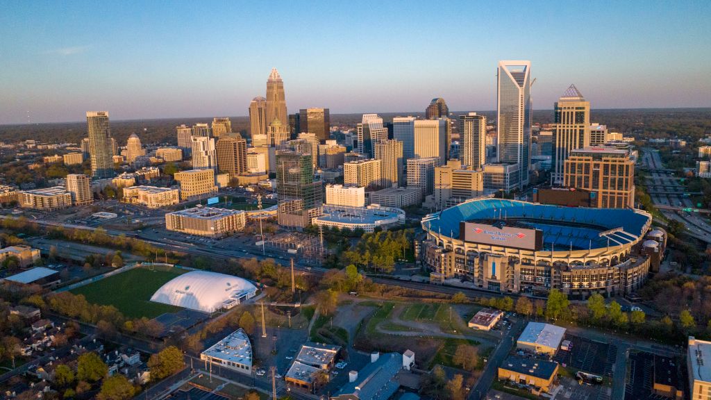 Aerial View of Charlotte, North Carolina on clear day showing highways and skyline and Bank of America Stadium