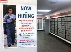 Now Hiring banner inside Post Office, Queens, New York