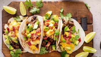 Breakfast tacos with sausage, eggs, bacon and avocado