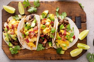 Breakfast tacos with sausage, eggs, bacon and avocado