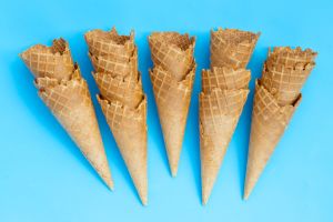 Empty ice cream cone on blue background.