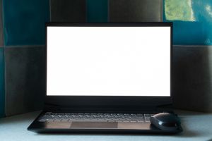 black laptop with white screen stands on the kitchen on the table at home, laptop with white screen, template, laptop