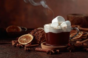 Hot chocolate with marshmallows on a dark brown background.