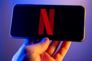 In this photo illustration, a Netflix logo seen displayed on...