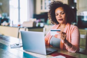 Woman at home investing in crypto currency