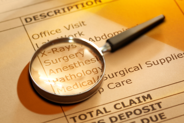 Magnifying Glass On Medical Invoice