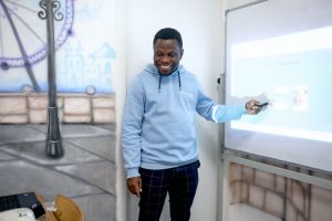 A young male teacher in the classroom