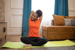 Young woman at home keeping fit by exercising