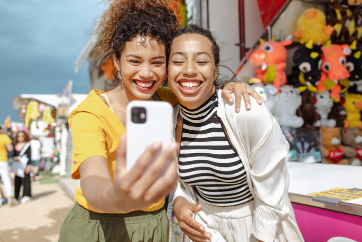 Portrait of young women using a mobile phone outdoors