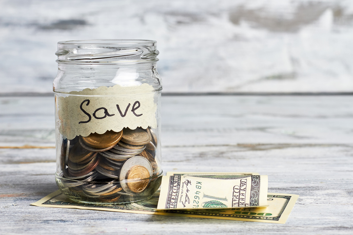 Dollars and container with coins.
