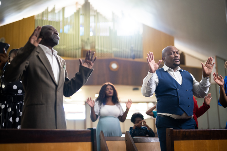Beautiful sunlight through window as congregation prays in church