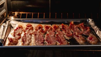 Deliciously cooked bacon in a roasting pan in an oven