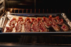 Deliciously cooked bacon in a roasting pan in an oven