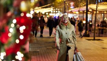 Senior woman walking back home after Christmas shopping