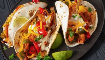 baked tex-mex chicken fajitas on a plate, top view
