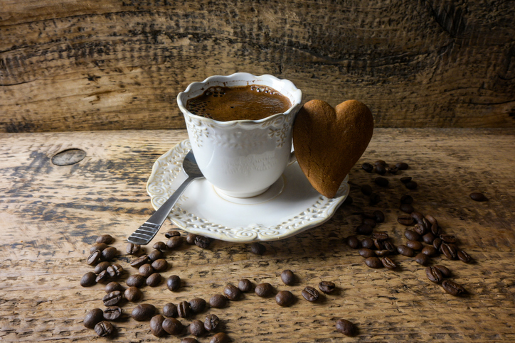 coffee in an old-fashioned mug and with gingerbread in the shape of a hear
