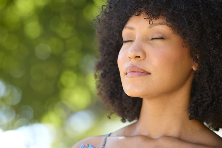 Woman Outdoors Relaxing In Countryside Closing Eyes And Breathing Deeply Enjoying Calm Of Nature