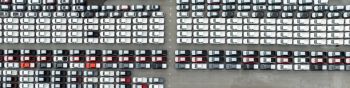 aerial top down view of a parking lot new cars lined up in the port for import and export international.