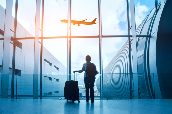 travel concept, woman in airport, passenger silhouette waiting with luggage