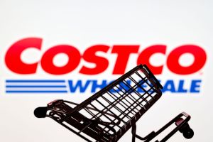 In this photo illustration, a shopping cart is seen in front...
