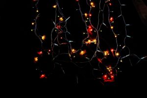 Christmas lights on a black background in the view