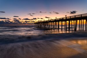 Silhouette of pier on beach against sky during sunset,Kitty Hawk,North Carolina,United States,USA