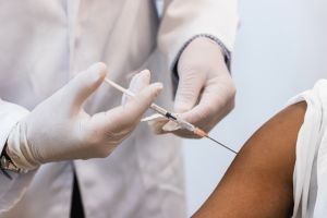 Doctor making injection for black woman patient