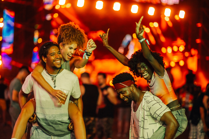 Friends celebrating at a vibrant music festival