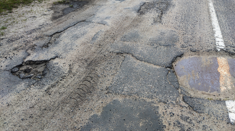 Dangerous Potholes in the Asphalt Town Road
