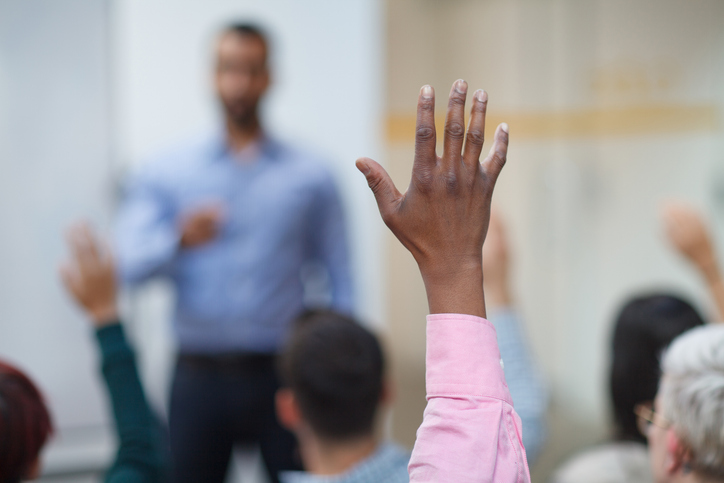 Black ethnicity man hand raised in class lecture training seminar in education school classroom asking question to teacher