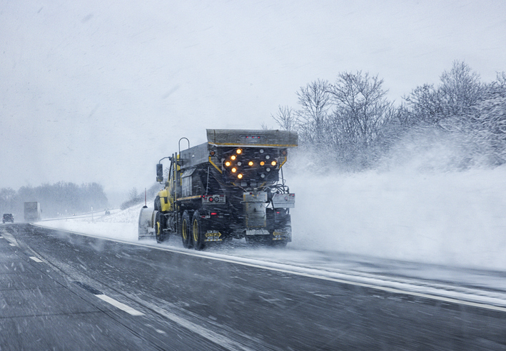 Car POV Passing Snow Plow Truck During Winter Snow Blizzard