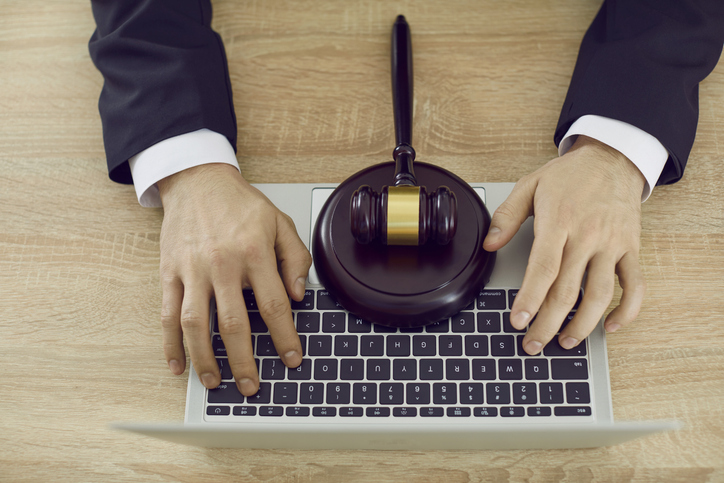 Lawyer using laptop, providing virtual law consultation and giving legal advice online