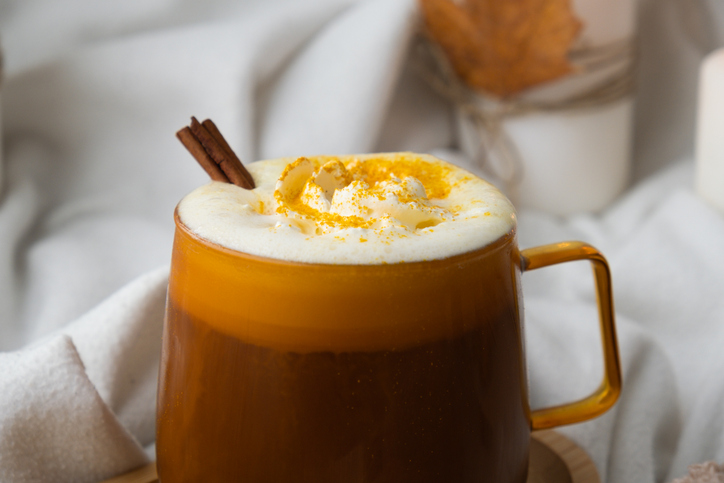 Pumpkin spiced latte morning warming coffee. Fall Drinks for Halloween Thanksgiving Holiday beverage Autumn spicy cinnamon flavor seasonal hot drinking in cozy orange cup. Atmosphere of cold rainy days